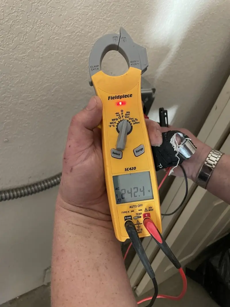 Voltage testing with clamp meter during Ceiling Fan Installation in Edgewater